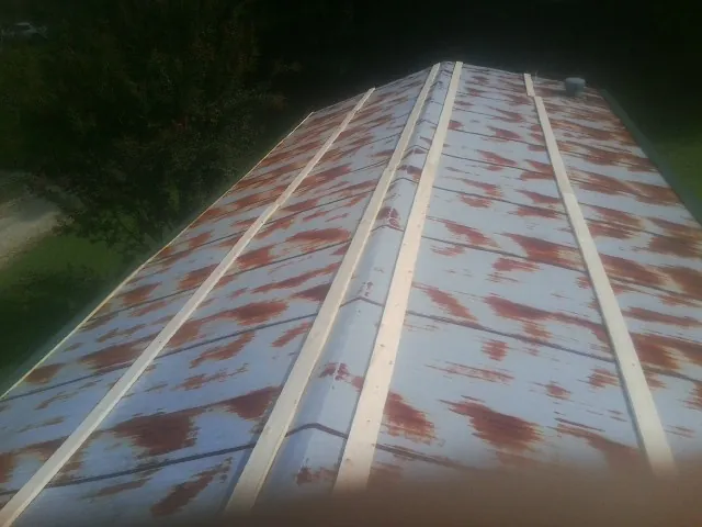 Rusted metal roof panels with new wood purlins before replacement — Storm Damage Roof Repair in Perkiomenville by Roofing Brothers